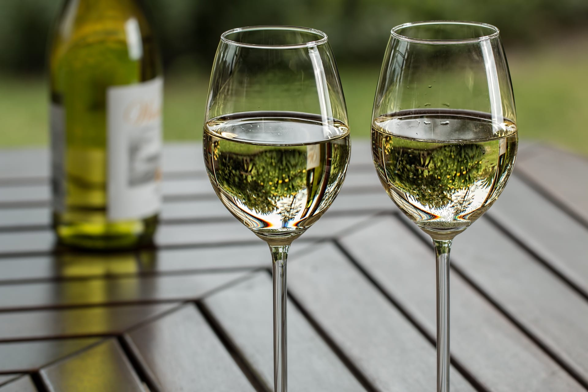 white wine, two glasses, a table